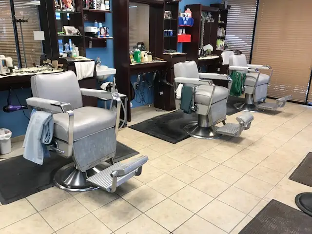 Three vintage chrome barber chairs inside Victorio’s Barber Shop